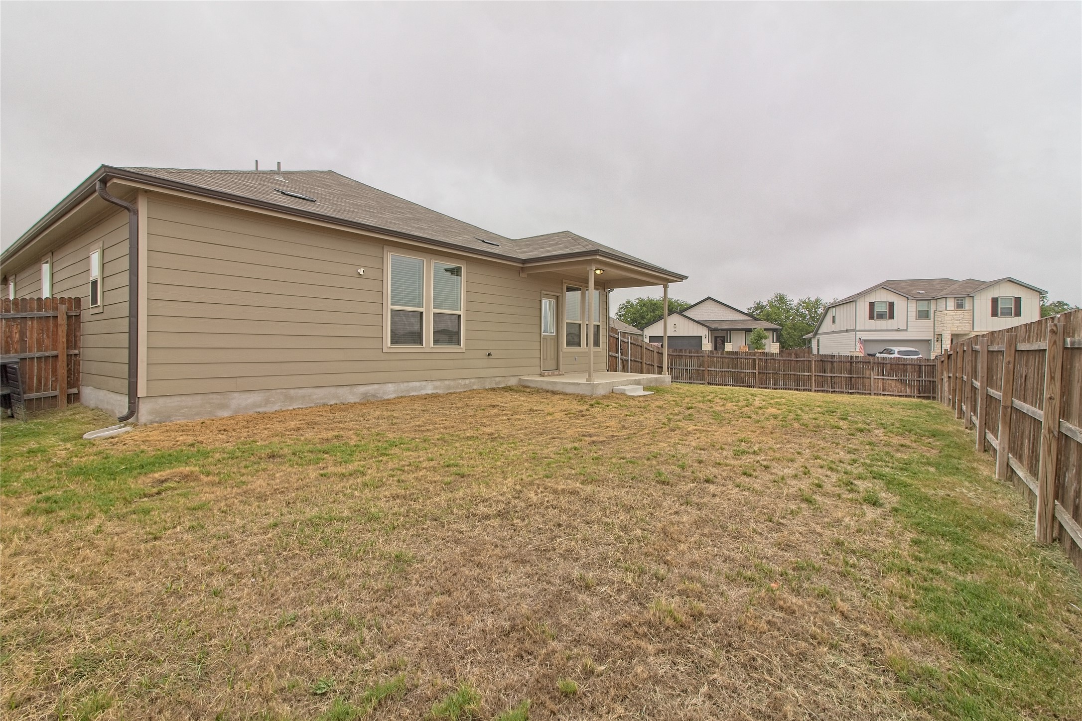 601 Hummingbird Lane Leander, TX 78641 - Photo 26 of 35 Back of property featuring a fenced backyard and a patio area