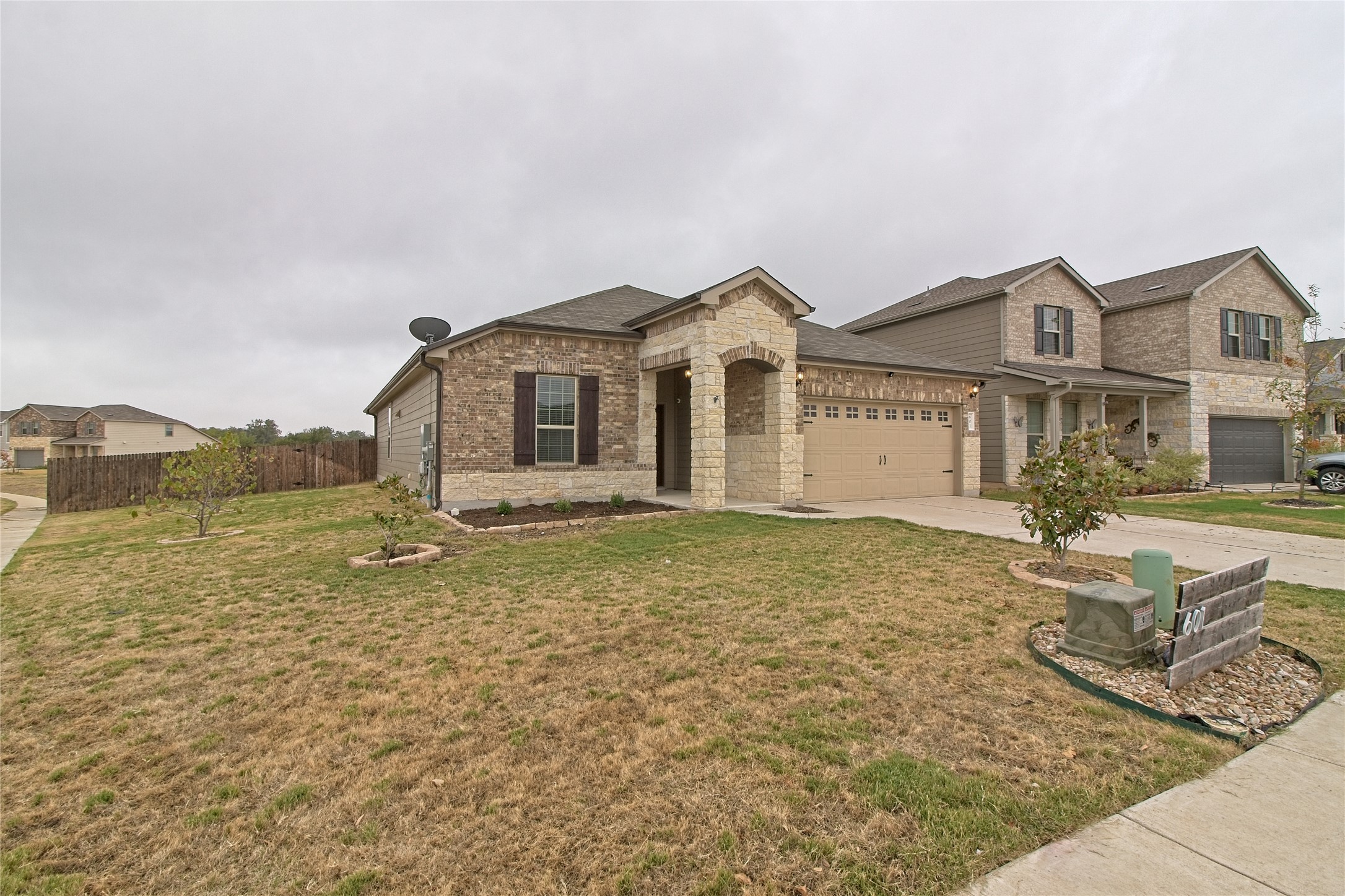 601 Hummingbird Lane Leander, TX 78641 - Photo 3 of 35 View of front of house with concrete driveway, brick siding, and a garage