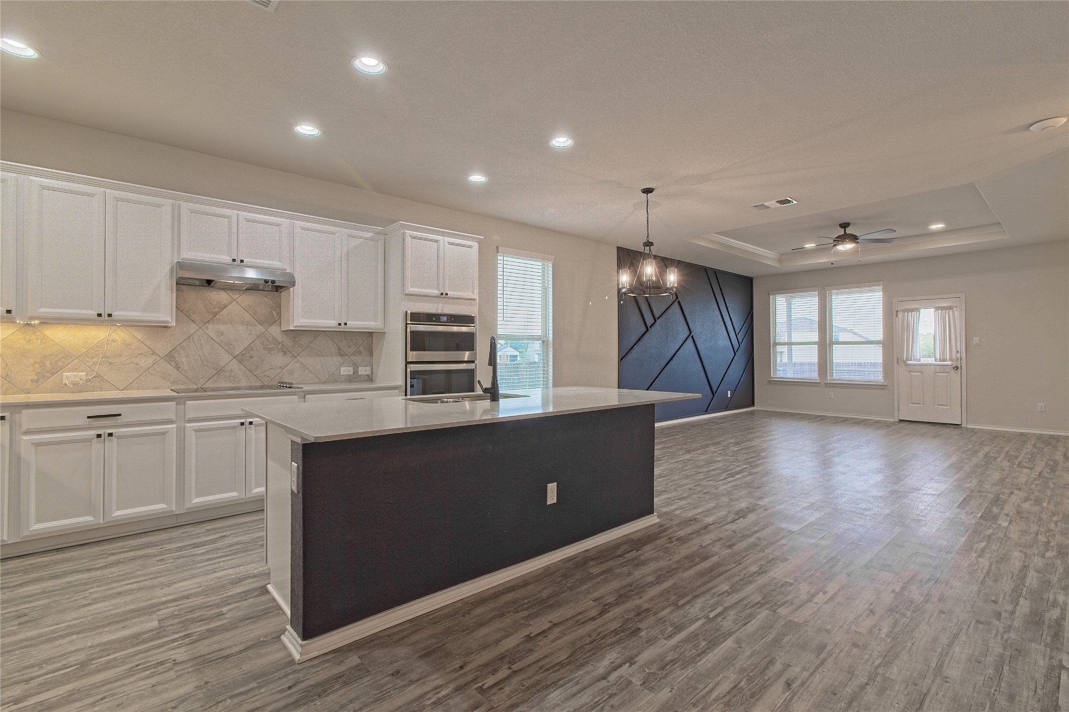 601 Hummingbird Lane Leander, TX 78641 - Photo 34 of 35 Kitchen featuring white cabinetry, suspended lighting, a ceiling fan, open floor plan, and dark wood-type flooring
