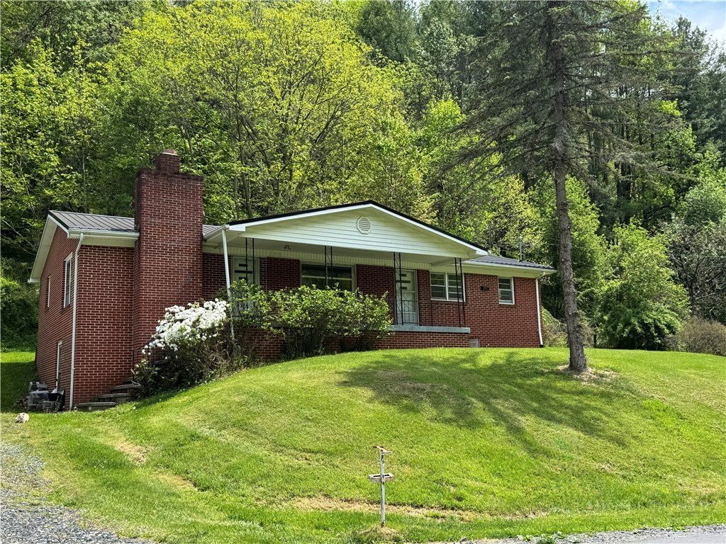 2510 Rich Hill Road Creston, NC 28615 - Photo 3 of 38 a front view of a house with garden