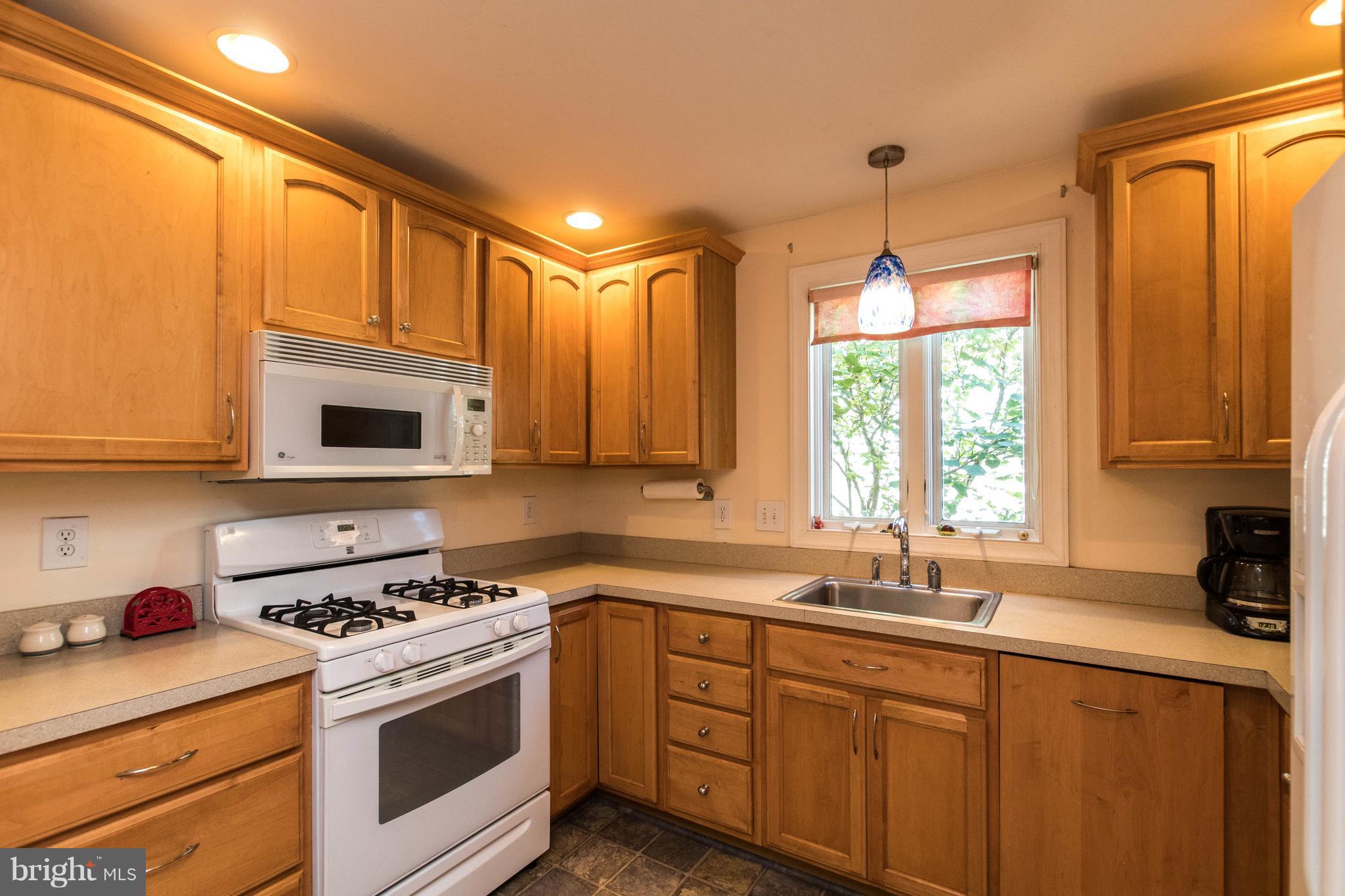 1117 Arran Road Baltimore, MD 21239 - Photo 11 of 25 a kitchen that has a sink a stove and cabinets