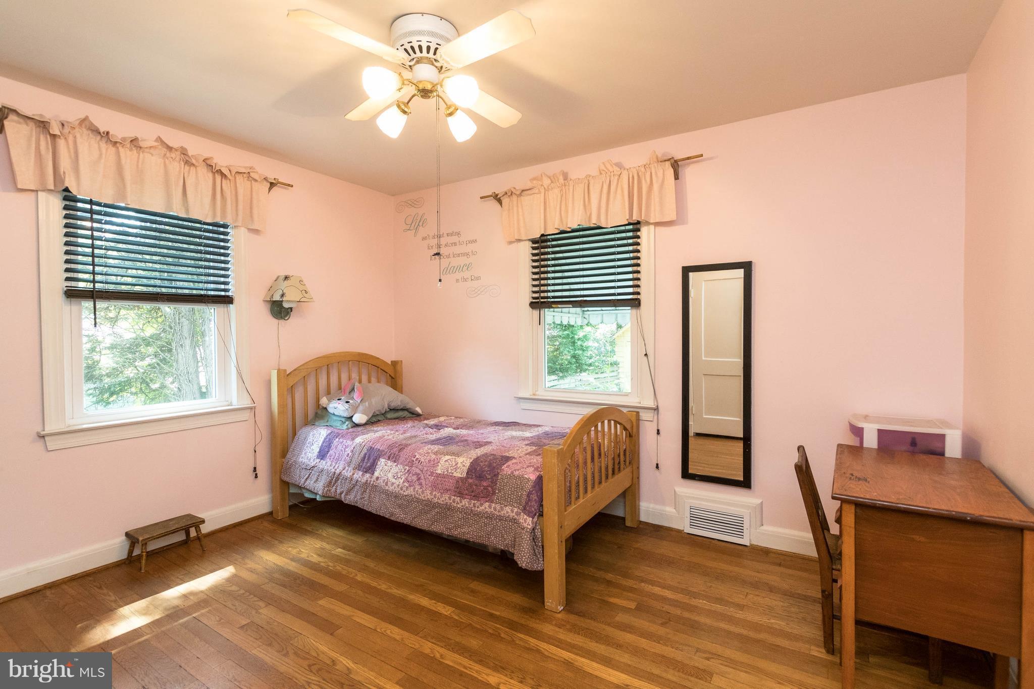 1117 Arran Road Baltimore, MD 21239 - Photo 16 of 25 a bedroom with a bed and wooden floor