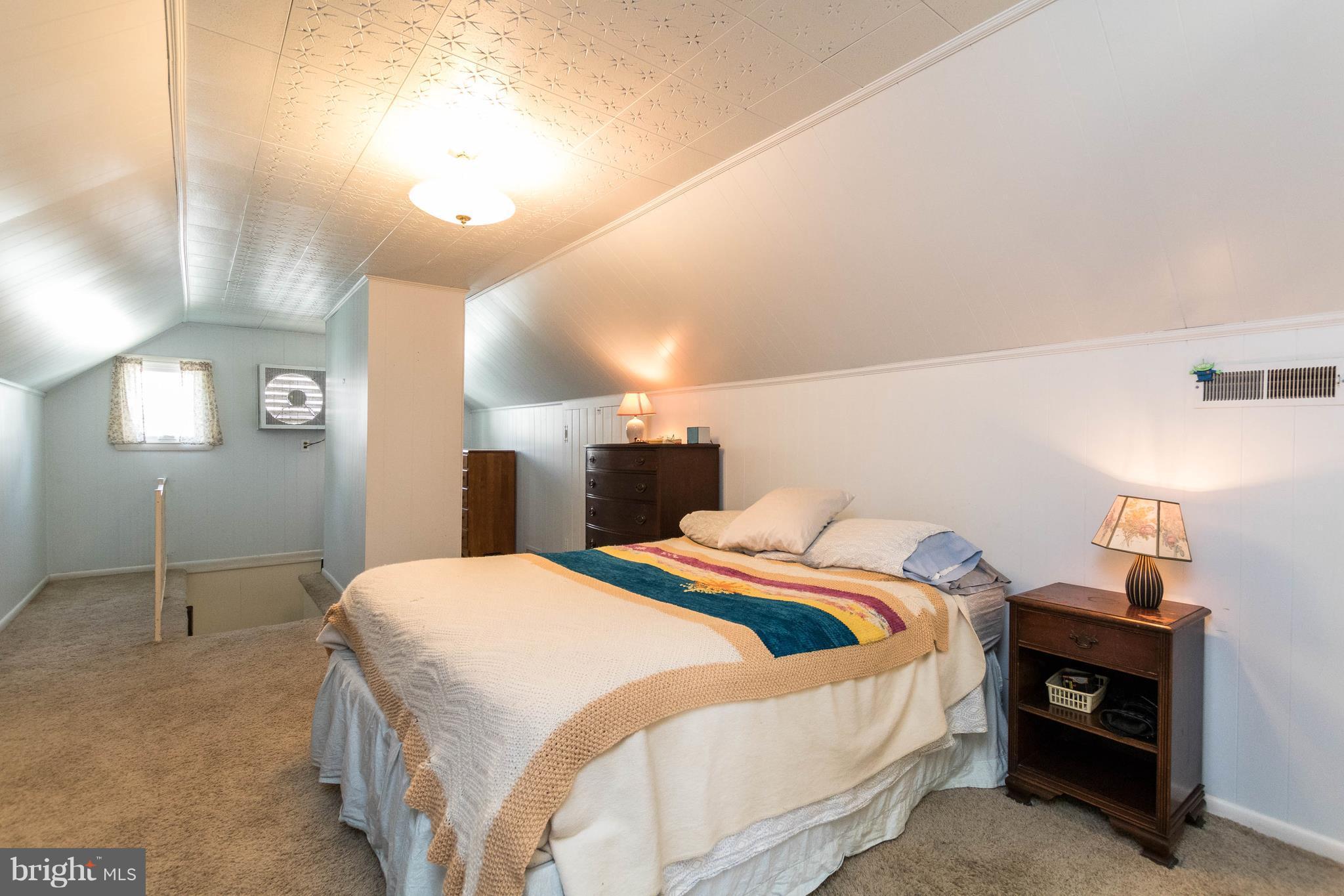 1117 Arran Road Baltimore, MD 21239 - Photo 21 of 25 a bedroom with a bed and a mirror
