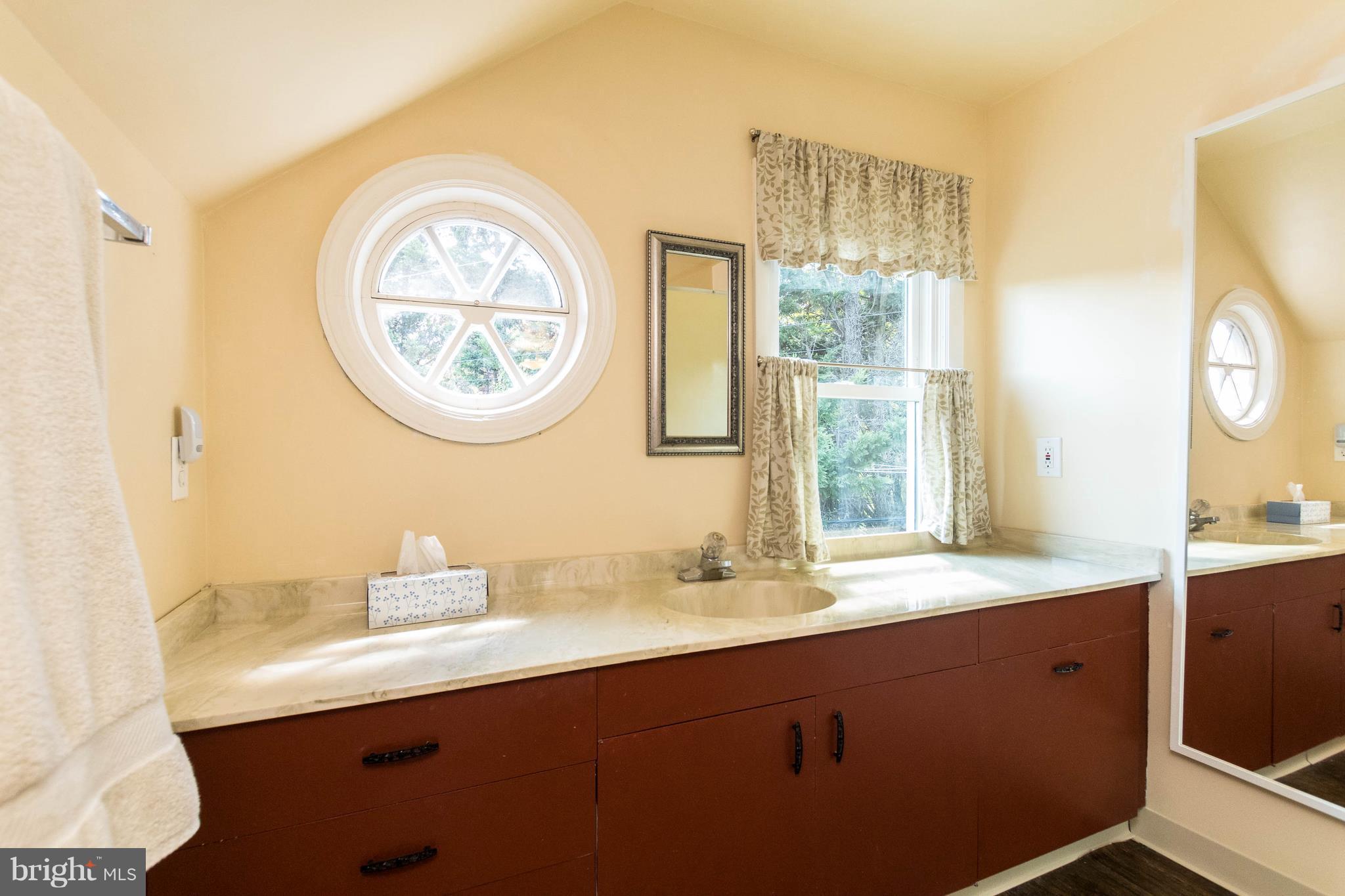 1117 Arran Road Baltimore, MD 21239 - Photo 22 of 25 a bathroom with a sink and a mirror