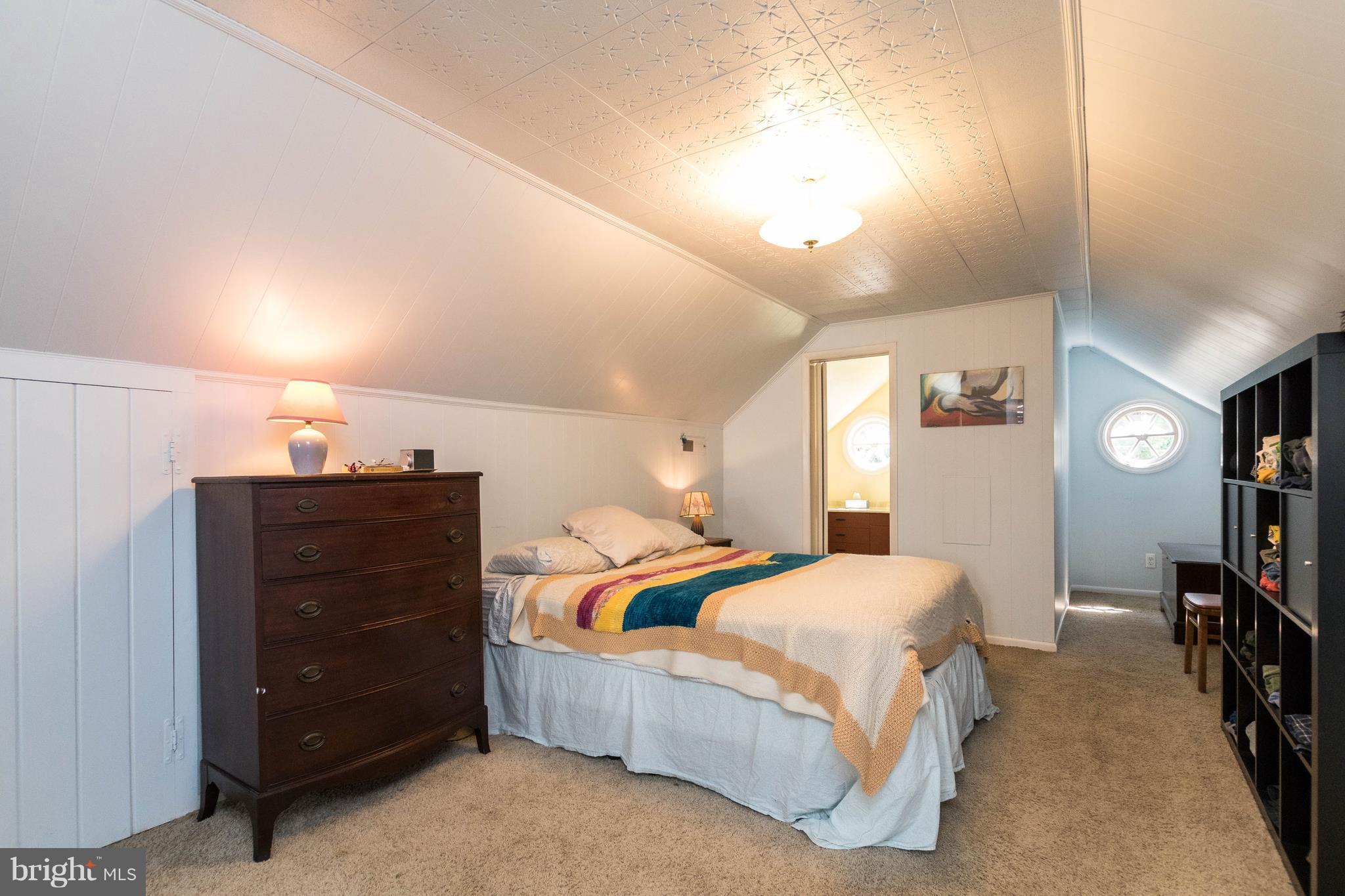 1117 Arran Road Baltimore, MD 21239 - Photo 5 of 25 a bedroom with a bed and a flat tv screen on dresser