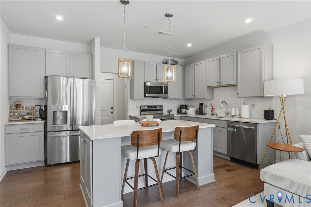 1900 Roseneath Road, Unit 4B Richmond, VA 23230 - Photo 5 of 44 a kitchen with stainless steel appliances granite countertop a refrigerator a stove a sink a microwave and white cabinets