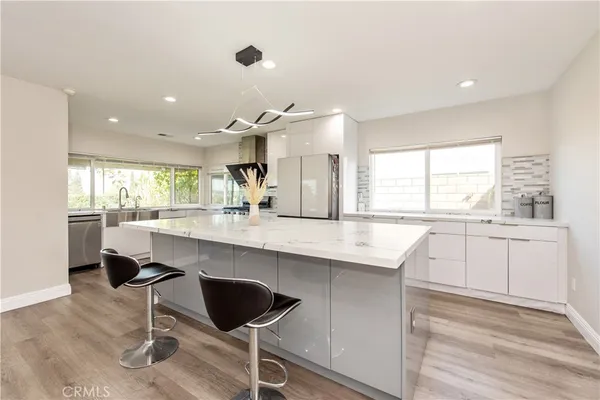 a kitchen with a sink cabinets and window