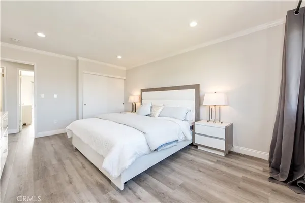 a bedroom with a bed and a lamp