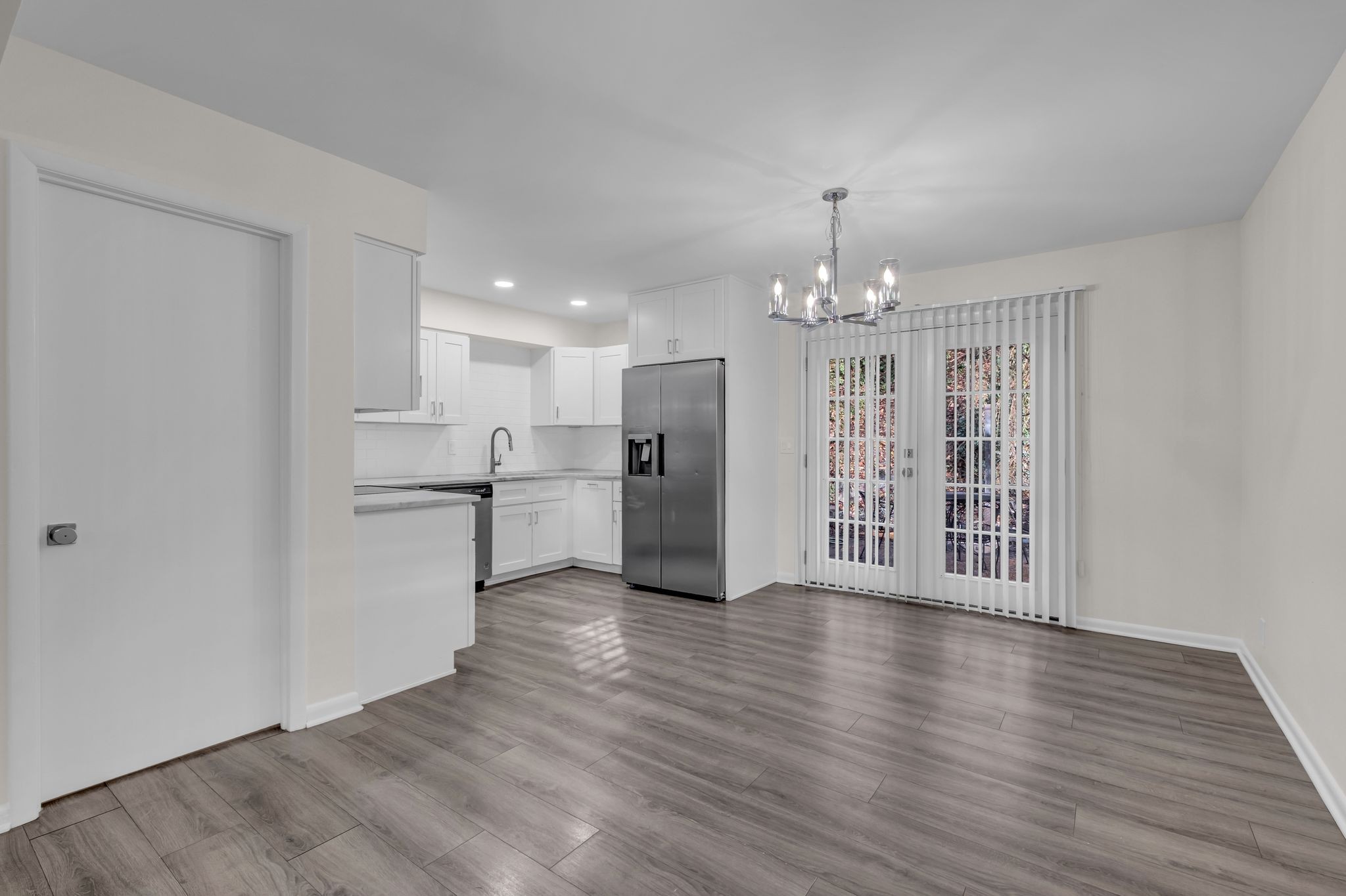 110 Bellevue Road, Unit 29 Nashville, TN 37221 - Photo 17 of 22 a view of an empty room with wooden floor and kitchen