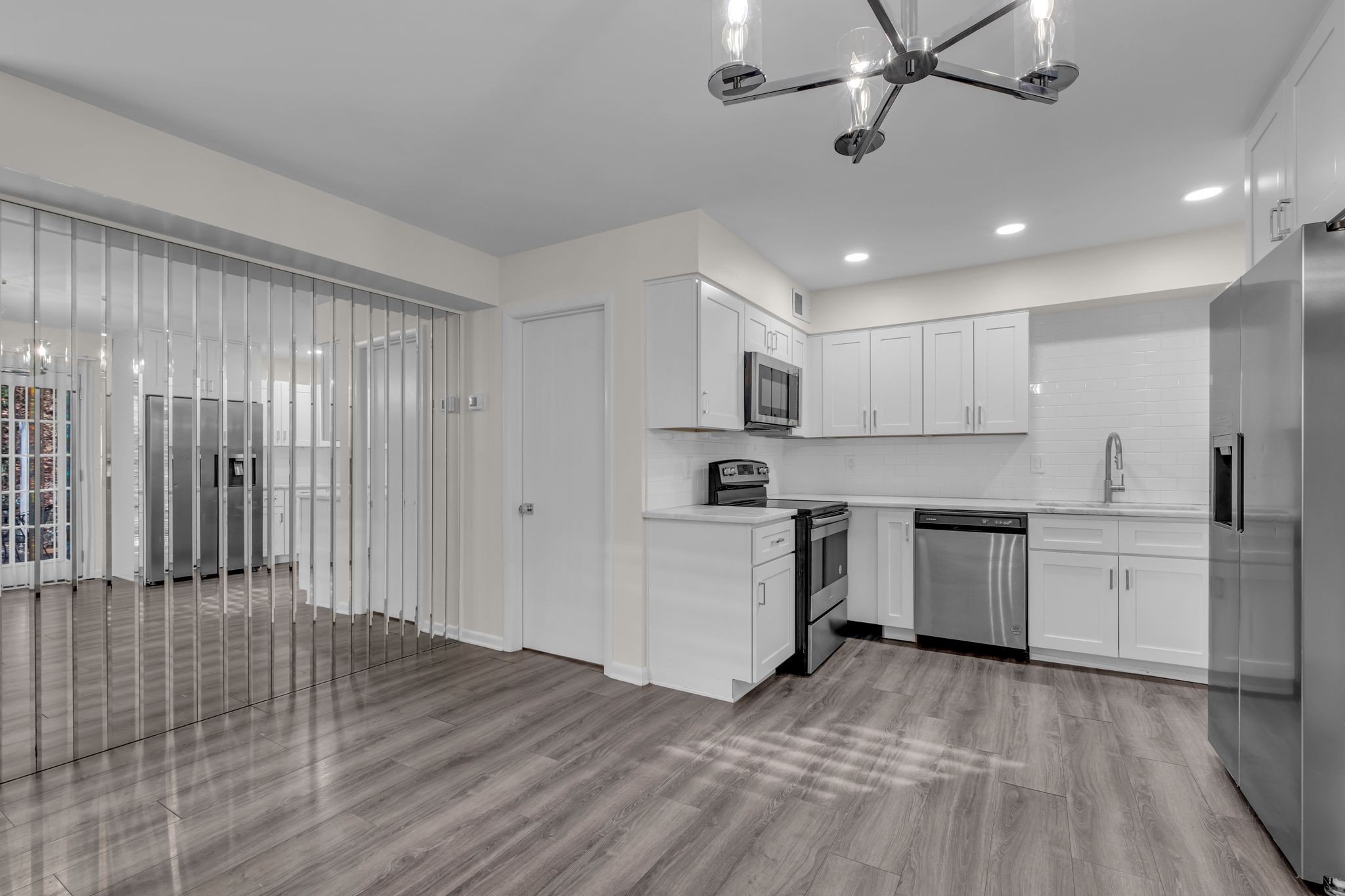 110 Bellevue Road, Unit 29 Nashville, TN 37221 - Photo 5 of 22 a kitchen with white cabinets stainless steel appliances and a fireplace