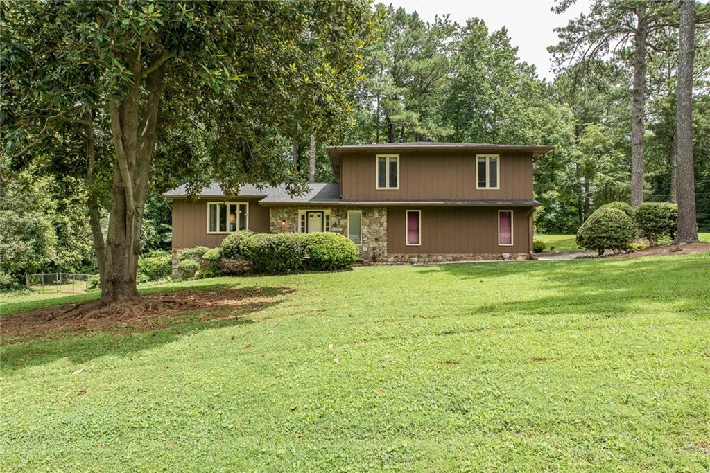Pristine setting with mature trees and landscaping on big corner lot.