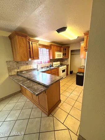 a kitchen with a sink a stove a microwave and cabinets