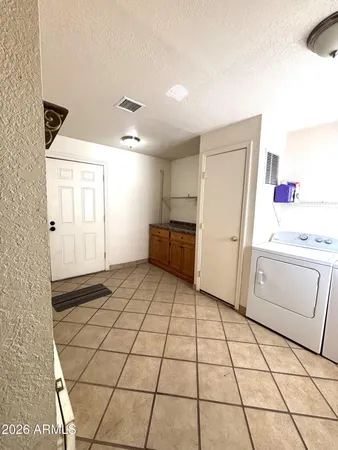a view of a kitchen with a sink and a refrigerator