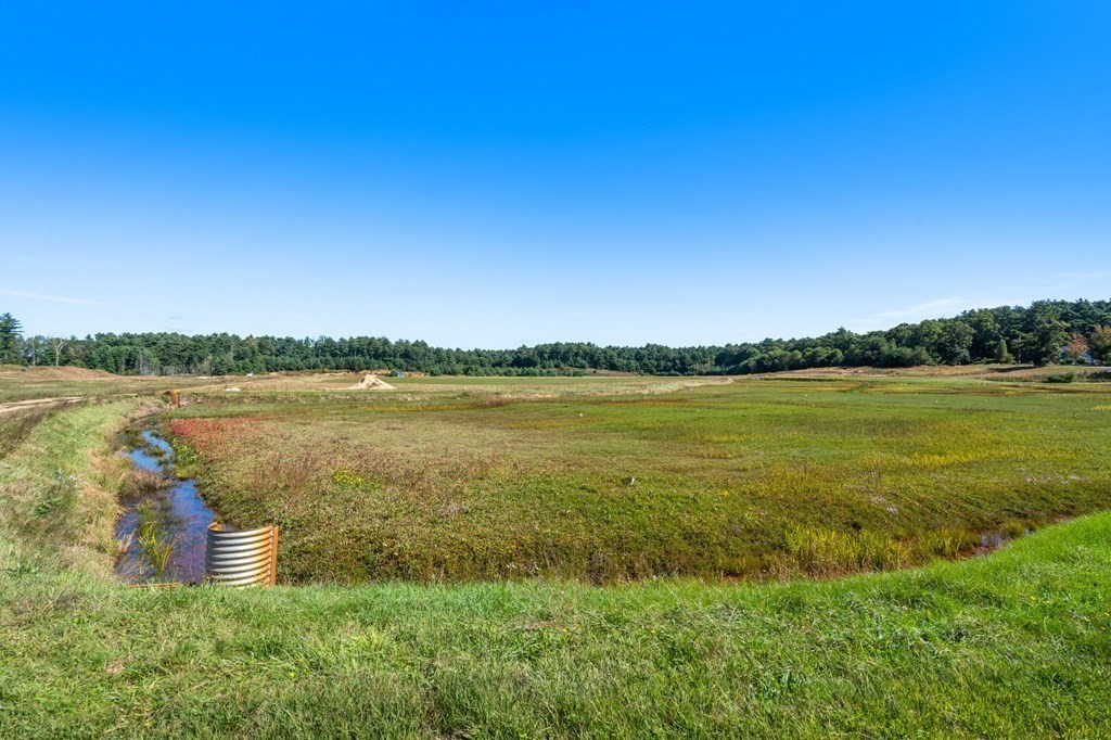0 Silva Street Carver, MA 02330 - Photo 21 of 25 a view of a lake with a house in the background