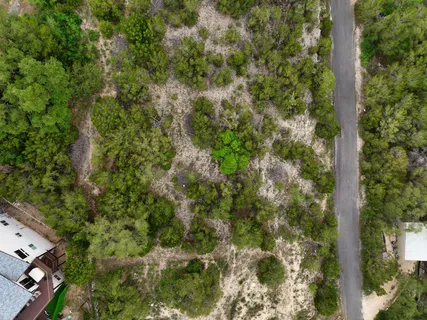 an aerial view of a houses with yard