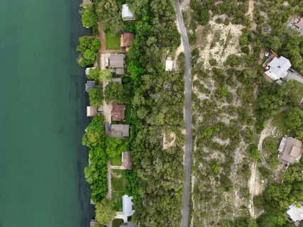 an aerial view of a houses with a lake view