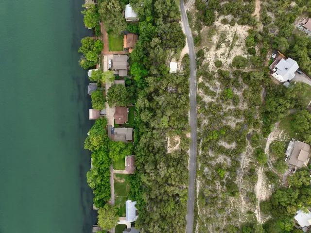 an aerial view of a houses with a lake view