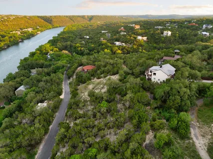 an aerial view of a houses with a lake view