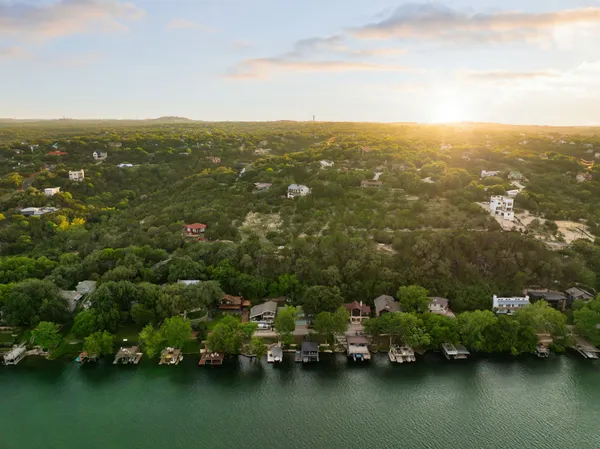 an aerial view of houses covered in trees
