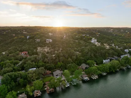 an aerial view of residential house with outdoor space and trees