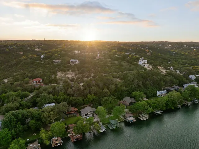 an aerial view of residential house with outdoor space and trees