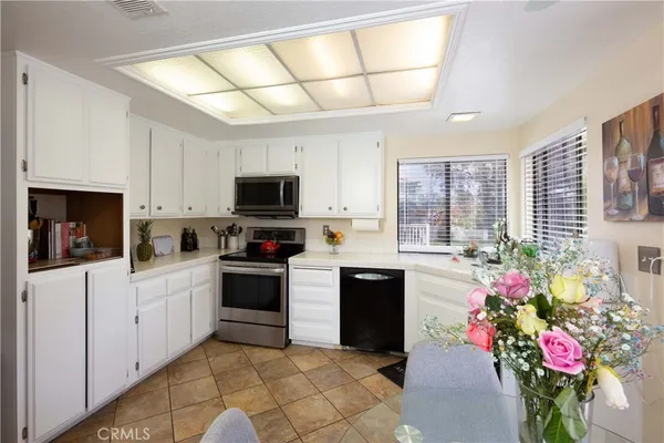 a kitchen with a refrigerator and microwave