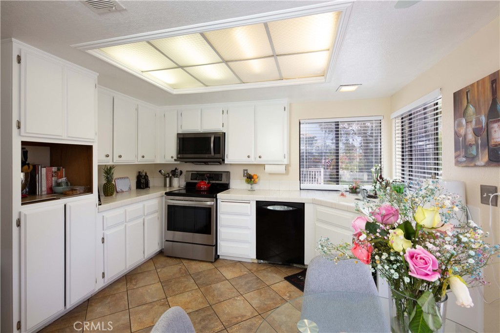 2583 Sandpebble Lane Brea, CA 92821 - Photo 11 of 27 a kitchen with a refrigerator and microwave