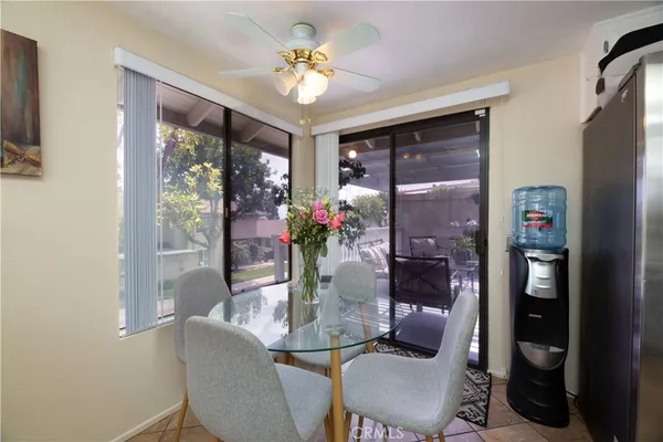 a view of a dining room with furniture a potted plant and a chandelier