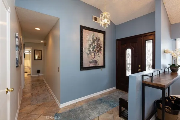a view of a hallway with workspace and a living room