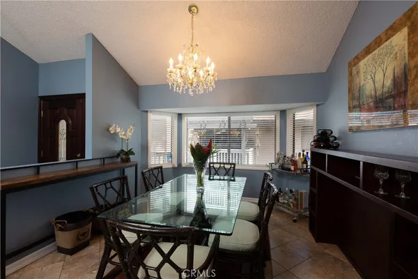 a view of a dining room with furniture and chandelier