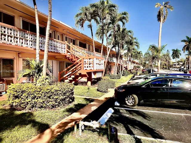 a view of a street that has couple of cars parked on the road