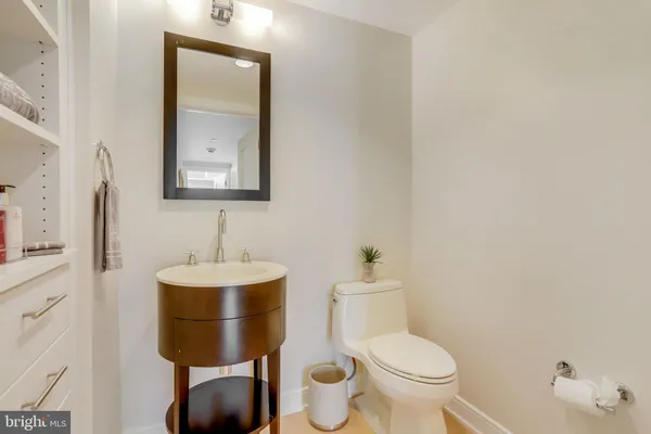 a bathroom with a toilet a sink and mirror
