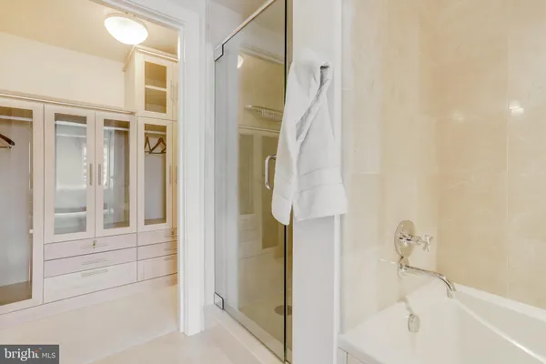 a bathroom with a glass shower door and a sink