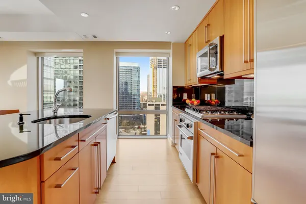 a kitchen with stainless steel appliances granite countertop a stove and a sink