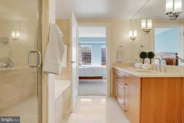 a bathroom with a glass shower door and a glass door
