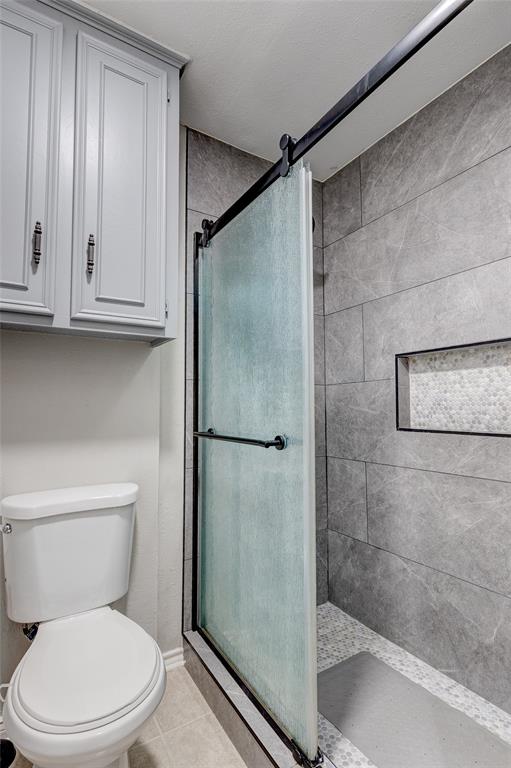 175 East Pleasant Run Road Cedar Hill, TX 75104 - Photo 22 of 39 a white toilet sitting next to a bathroom