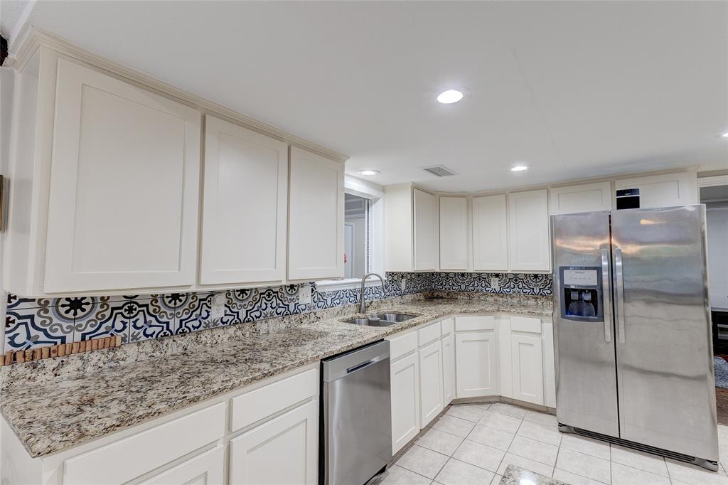 175 East Pleasant Run Road Cedar Hill, TX 75104 - Photo 26 of 39 a kitchen with granite countertop white cabinets and white stainless steel appliances