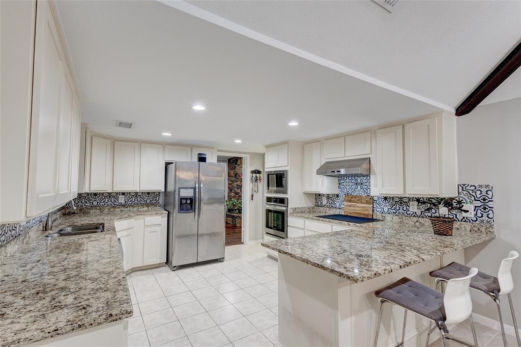 175 East Pleasant Run Road Cedar Hill, TX 75104 - Photo 27 of 39 a kitchen with stainless steel appliances granite countertop a stove and a refrigerator