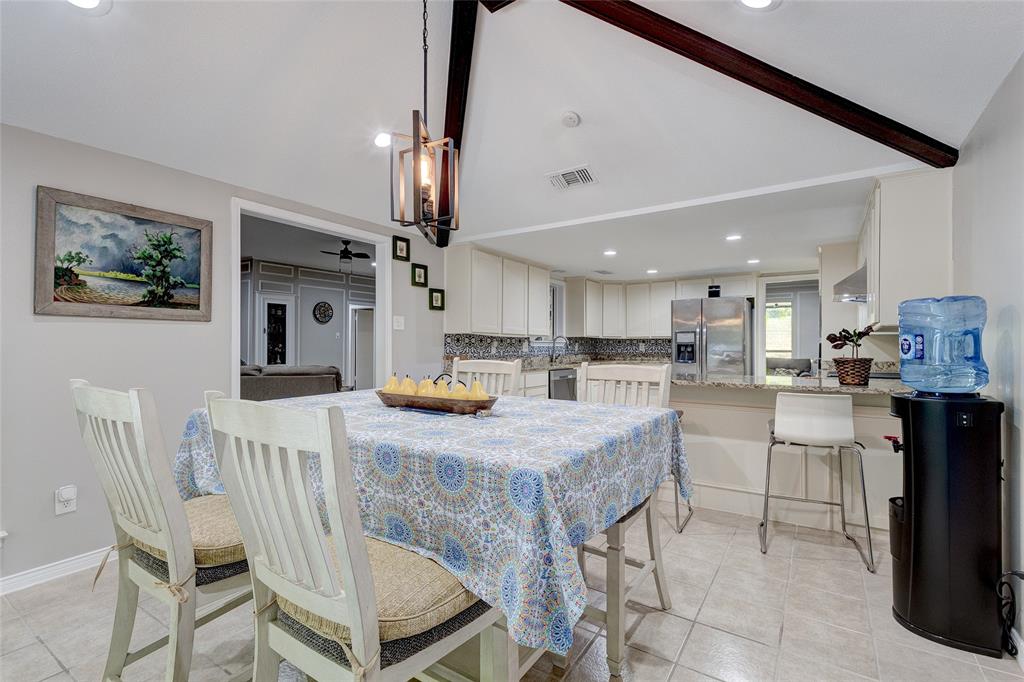175 East Pleasant Run Road Cedar Hill, TX 75104 - Photo 29 of 39 a kitchen with kitchen island a stove a table and chairs in it