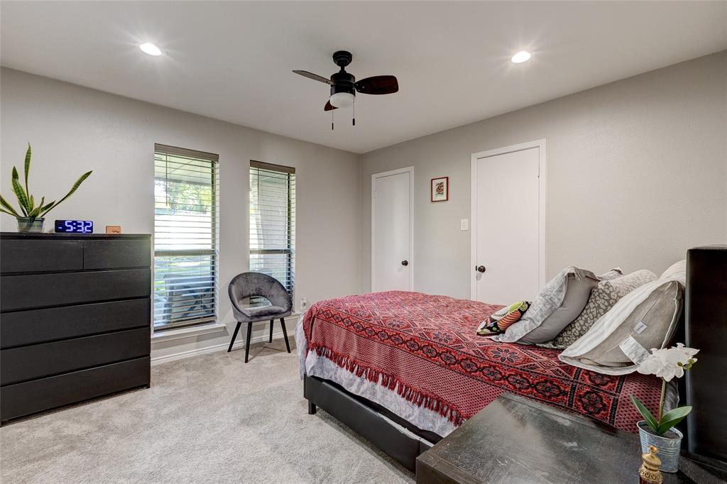 175 East Pleasant Run Road Cedar Hill, TX 75104 - Photo 31 of 39 a bedroom with a bed and a chandelier