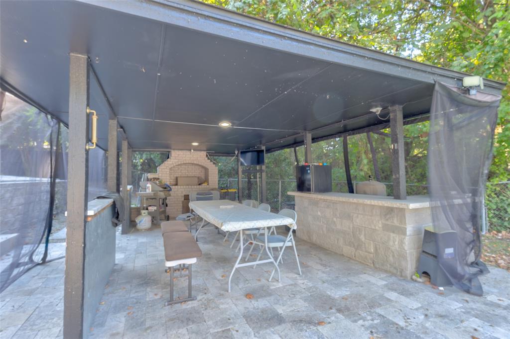 175 East Pleasant Run Road Cedar Hill, TX 75104 - Photo 9 of 39 a patio with a table and chairs and potted plants