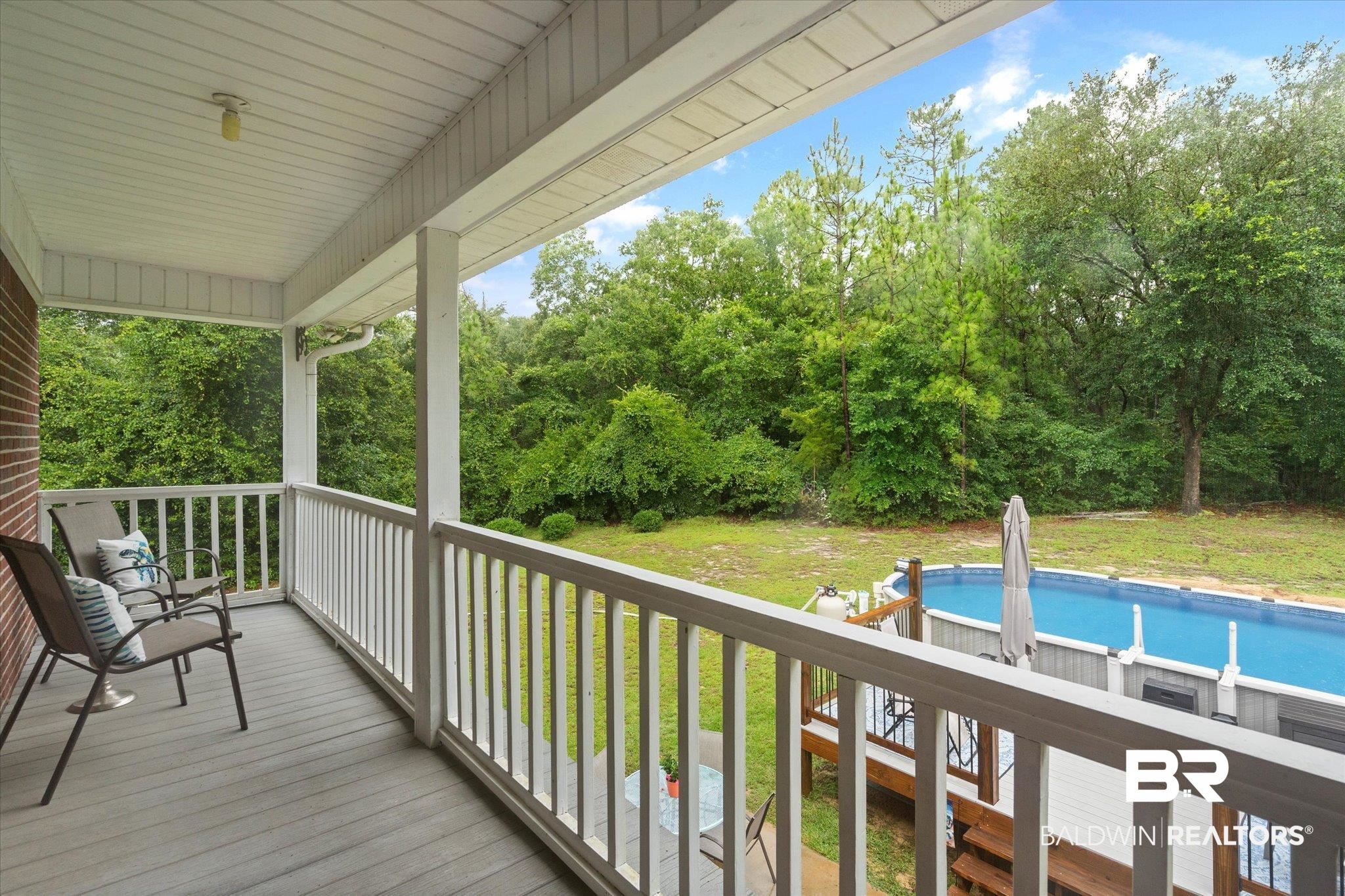 2300 Radcliff Road Saraland, AL 36571 - Photo 23 of 56 Wooden terrace with an outdoor pool and a yard
