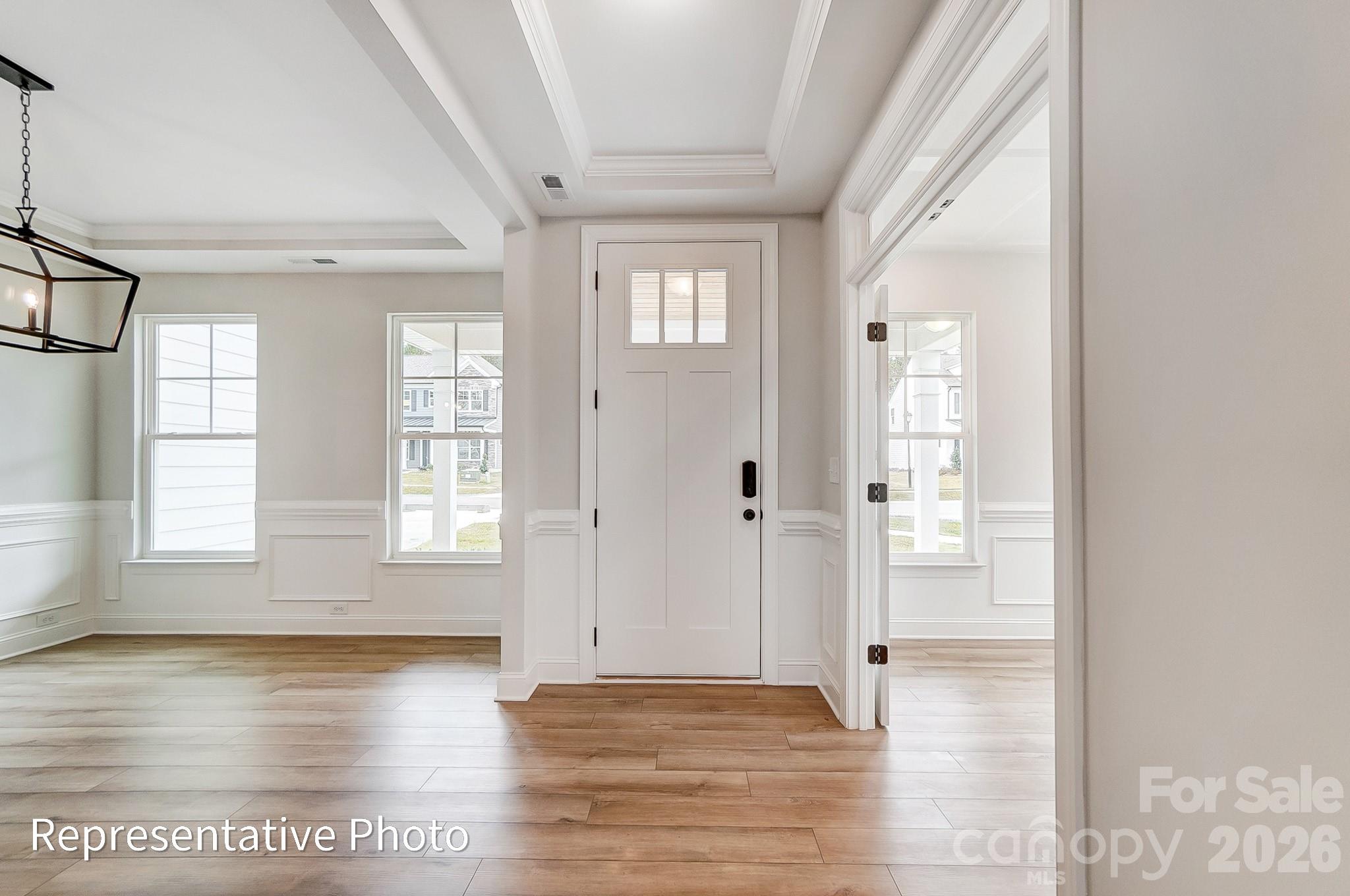 5058 Mclaughlin Loop Waxhaw, NC 28173 - Photo 13 of 42 a view of an empty room with window and wooden floor