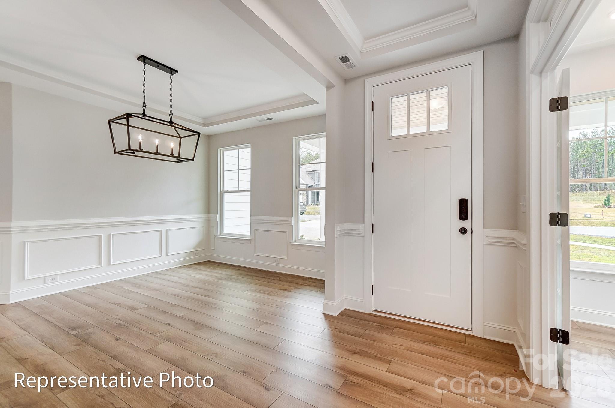 5058 Mclaughlin Loop Waxhaw, NC 28173 - Photo 14 of 42 a view of a room with wooden floor and windows