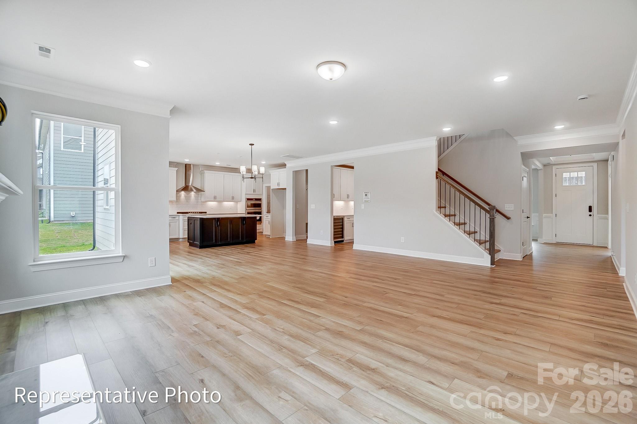 5058 Mclaughlin Loop Waxhaw, NC 28173 - Photo 17 of 42 a view of livingroom with hardwood floor and a ceiling fan