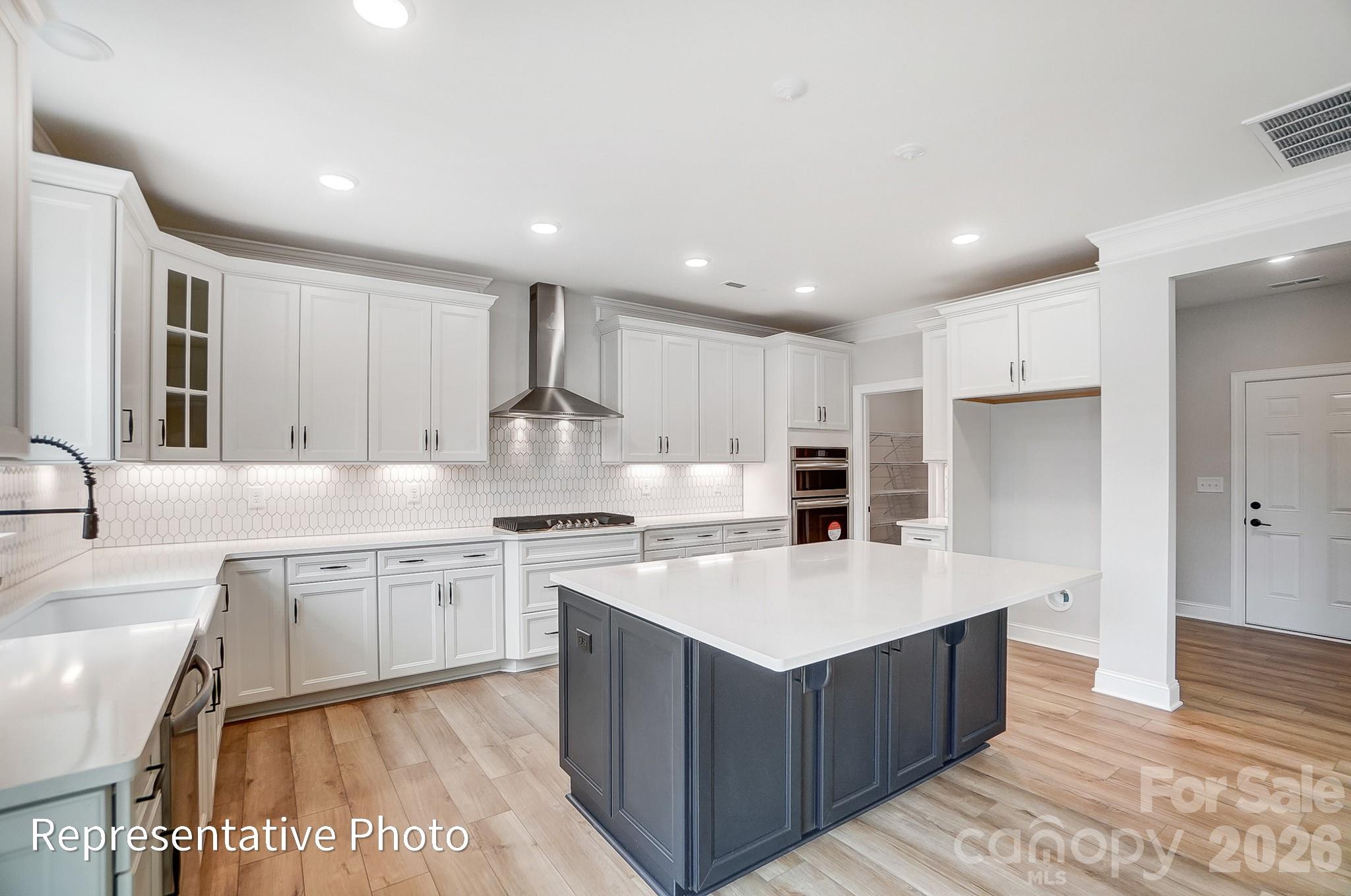 5058 Mclaughlin Loop Waxhaw, NC 28173 - Photo 20 of 42 a large kitchen with stainless steel appliances granite countertop a large counter top and a sink