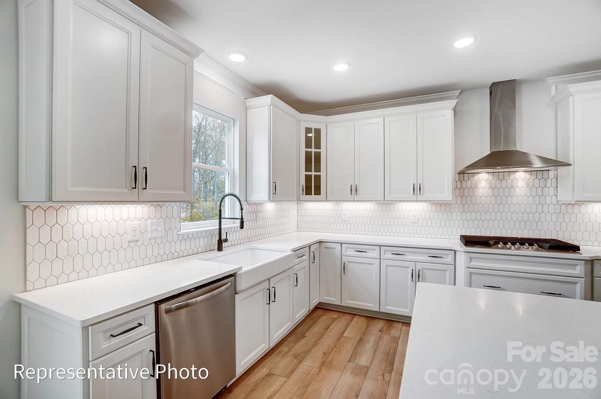 5058 Mclaughlin Loop Waxhaw, NC 28173 - Photo 21 of 42 a kitchen with stainless steel appliances granite countertop a sink stove and cabinets