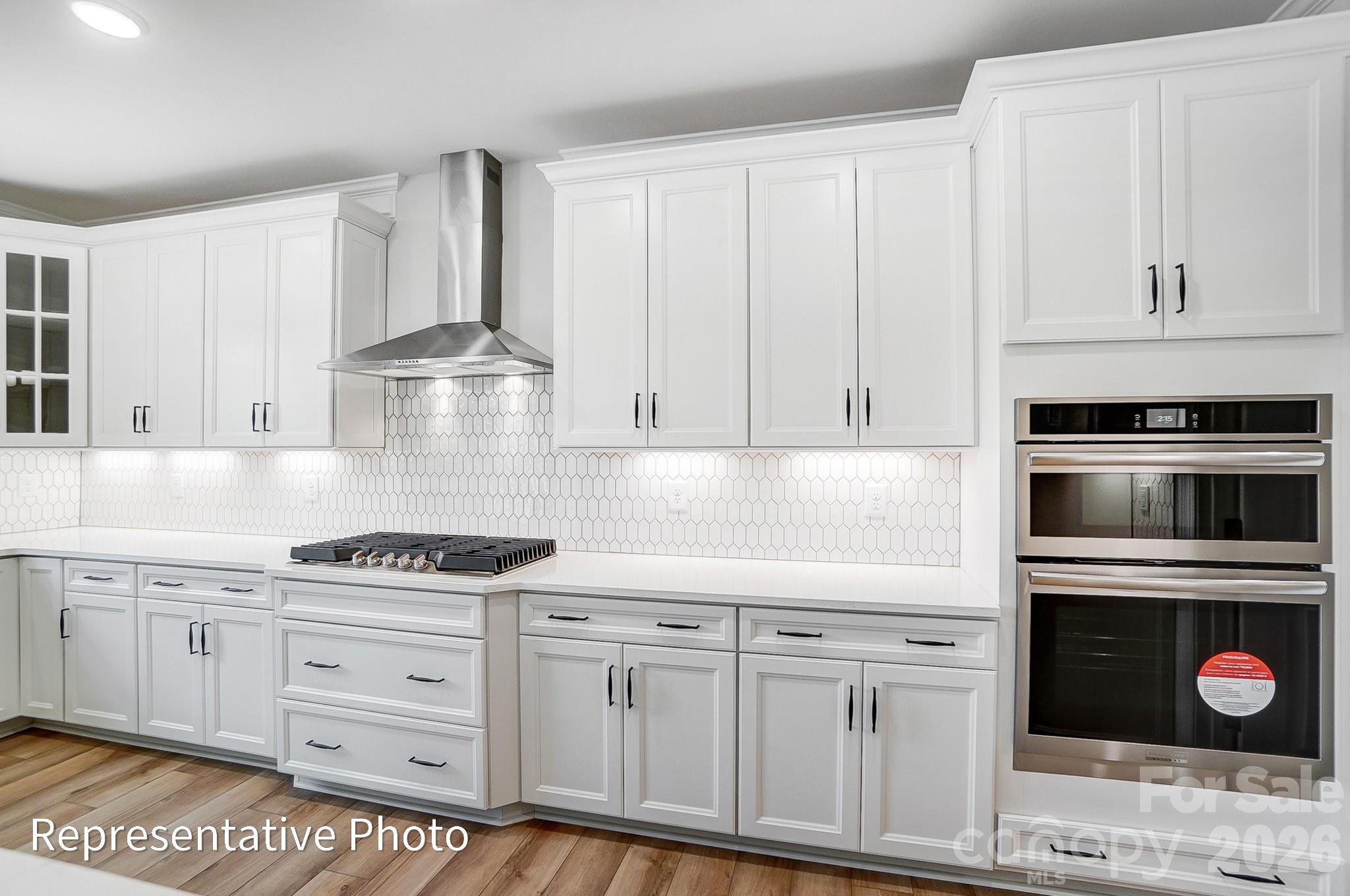 5058 Mclaughlin Loop Waxhaw, NC 28173 - Photo 23 of 42 a kitchen with granite countertop a stove a sink and cabinets
