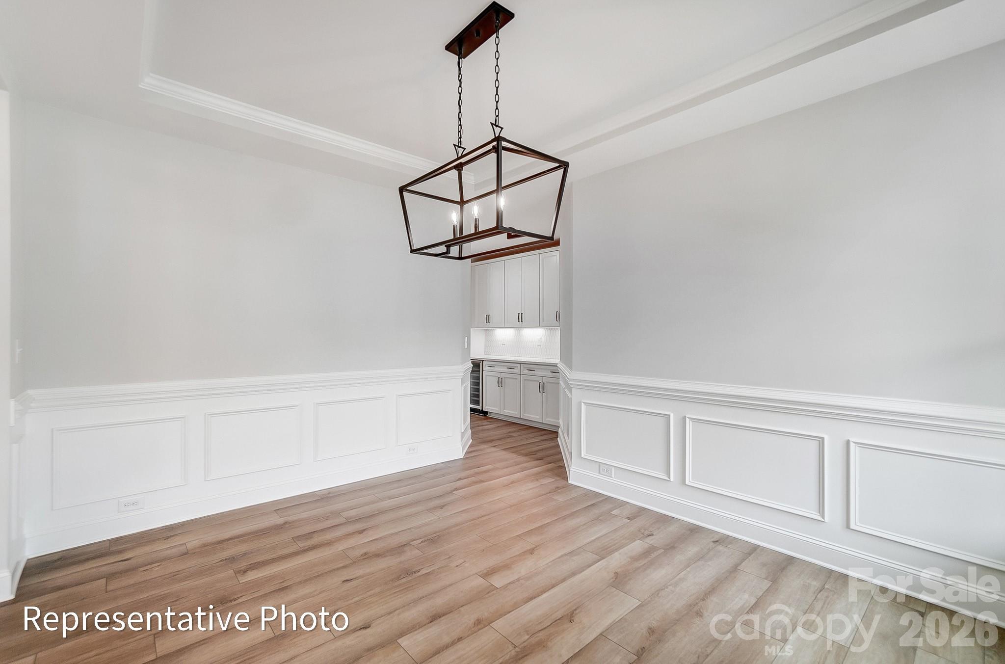 5058 Mclaughlin Loop Waxhaw, NC 28173 - Photo 26 of 42 a view of empty room with wooden floor and ceiling fan