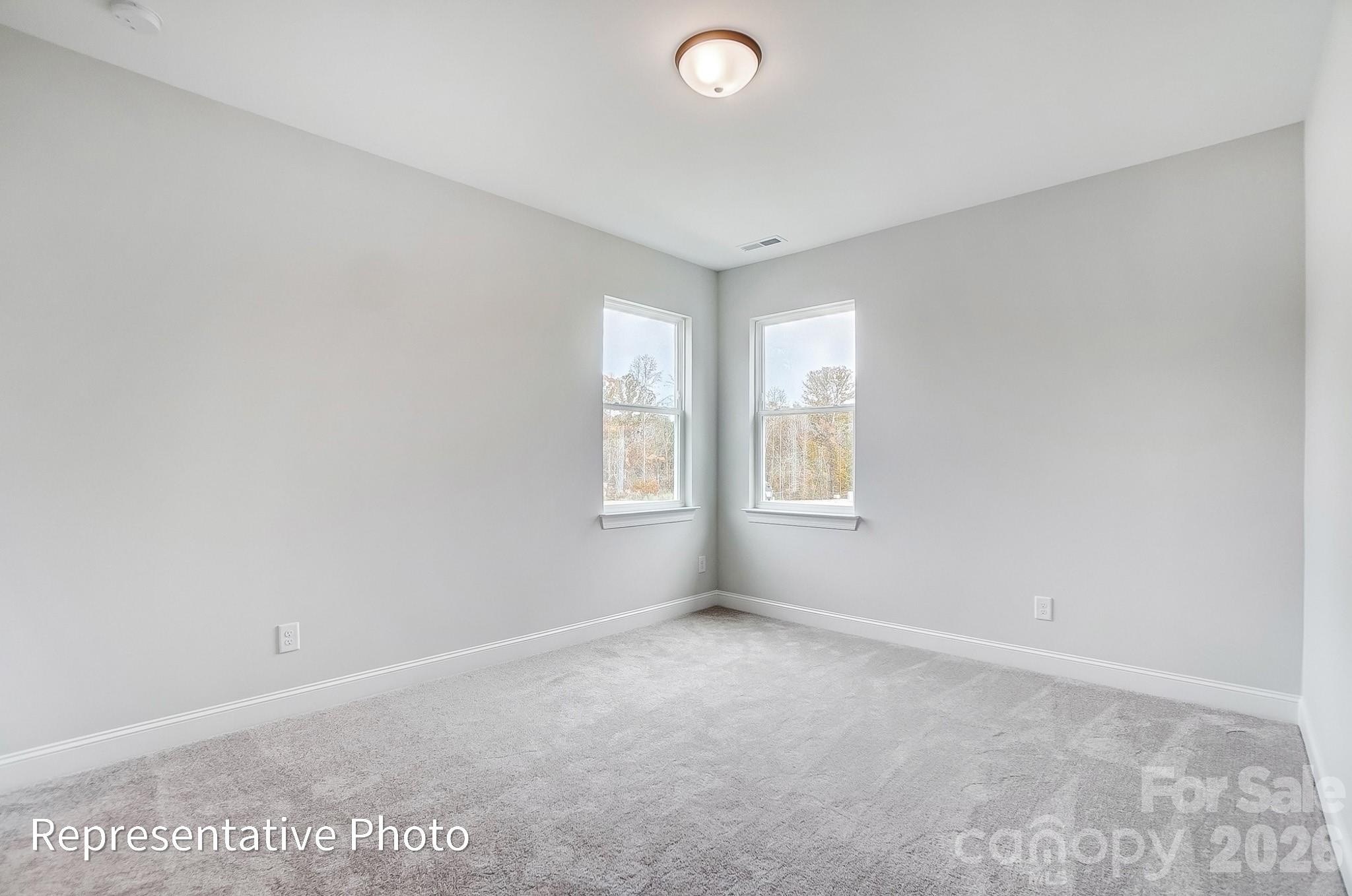 5058 Mclaughlin Loop Waxhaw, NC 28173 - Photo 40 of 42 an empty room with windows and closet